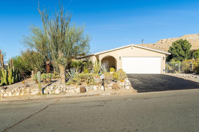 ranch-style house with a mountain view and a garage