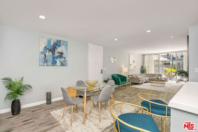 dining space with light hardwood / wood-style flooring