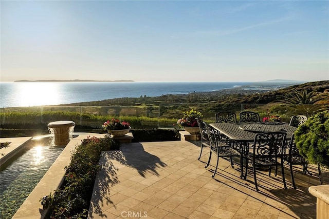 view of patio with a water view