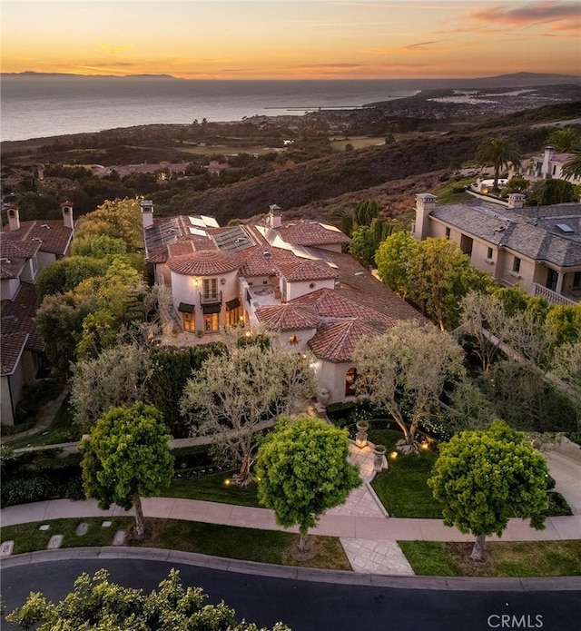 aerial view at dusk with a water view