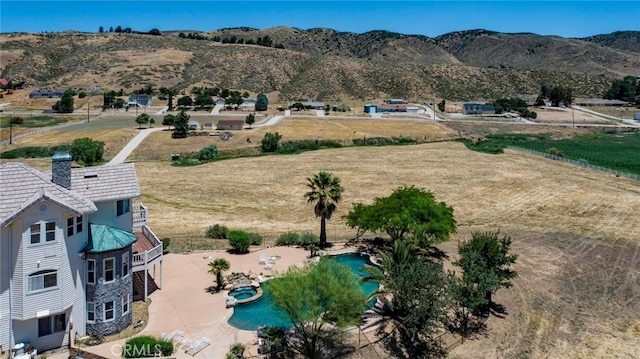 birds eye view of property with a mountain view