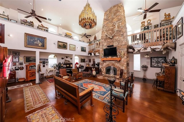 living room with a towering ceiling and a fireplace