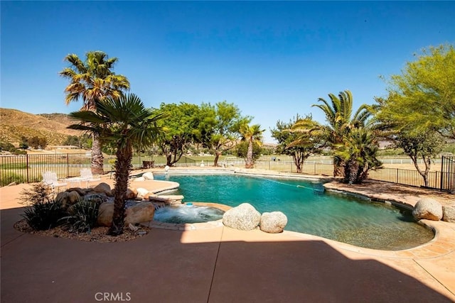 view of swimming pool with a patio area and a mountain view