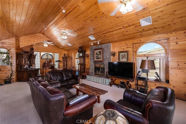 living room featuring lofted ceiling, carpet flooring, wood walls, and wooden ceiling