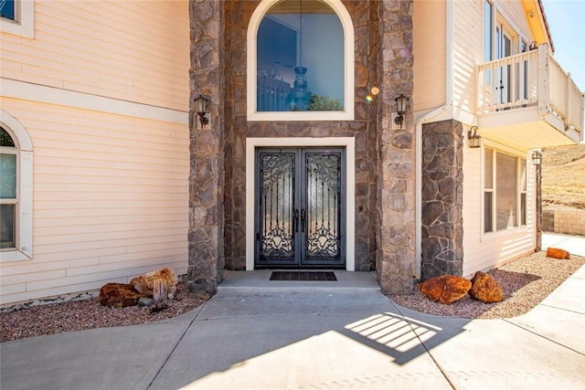 entrance to property featuring french doors and a balcony