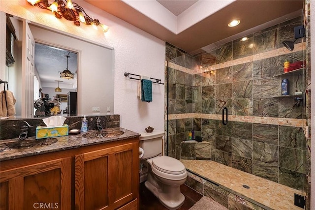 bathroom with toilet, vanity, and an enclosed shower