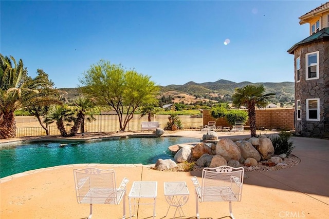 view of pool featuring a patio area and a mountain view