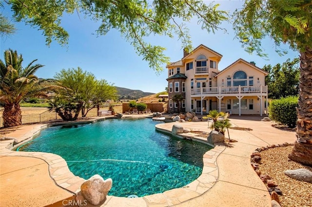 view of swimming pool featuring a mountain view and a patio