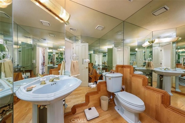 bathroom featuring hardwood / wood-style floors and double sink