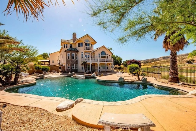 view of pool featuring a patio area and an in ground hot tub