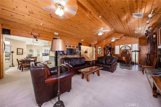 carpeted living room with lofted ceiling, wood ceiling, a wealth of natural light, and wood walls