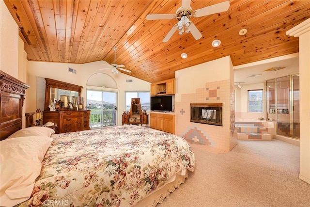 carpeted bedroom featuring lofted ceiling, a tiled fireplace, multiple windows, and wooden ceiling