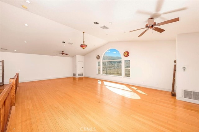 interior space with visible vents, baseboards, lofted ceiling, ceiling fan, and light wood-style floors