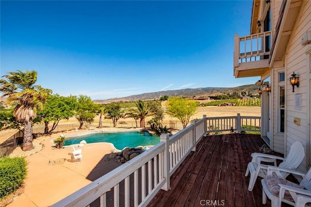 view of pool featuring a deck with mountain view and a fenced in pool