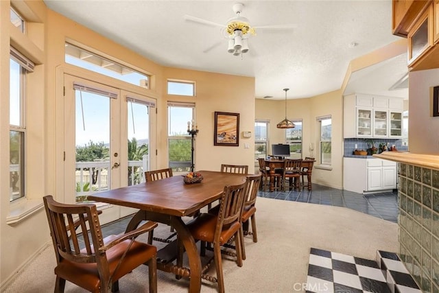 dining area featuring dark tile patterned flooring, french doors, and dark carpet