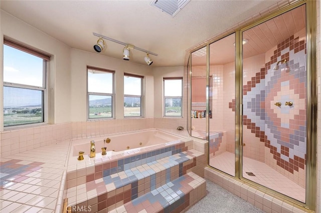 full bathroom featuring a tub with jets, a shower stall, visible vents, and tile patterned floors