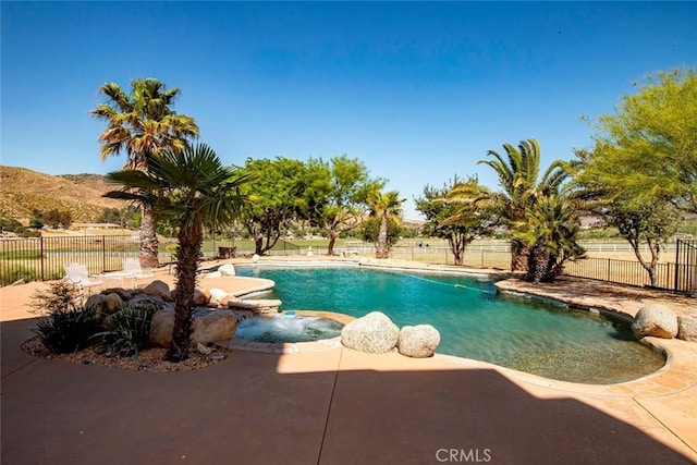 view of swimming pool featuring a patio, fence, and a fenced in pool