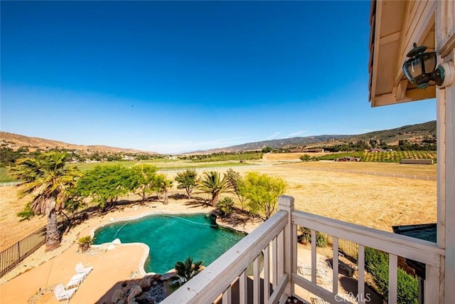 view of yard with a mountain view, a fenced in pool, and a rural view