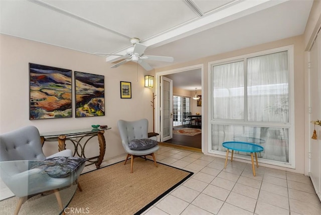 living area featuring ceiling fan and light tile patterned floors