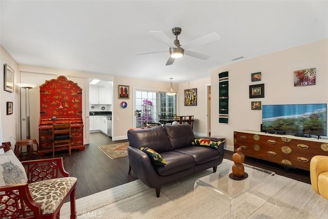 living room featuring ceiling fan and hardwood / wood-style floors