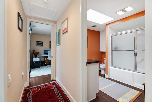 corridor featuring dark hardwood / wood-style floors