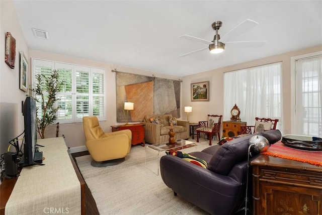 living room with ceiling fan and hardwood / wood-style flooring