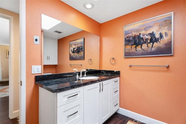 bathroom featuring wood-type flooring and vanity