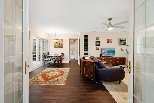 living room with ceiling fan, a healthy amount of sunlight, french doors, and dark wood-type flooring