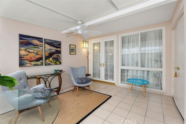 living area featuring ceiling fan, light tile patterned floors, and french doors