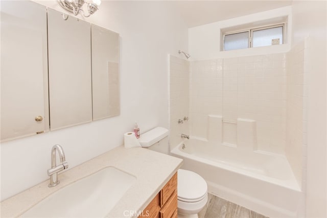 full bathroom featuring toilet, vanity, and bathing tub / shower combination