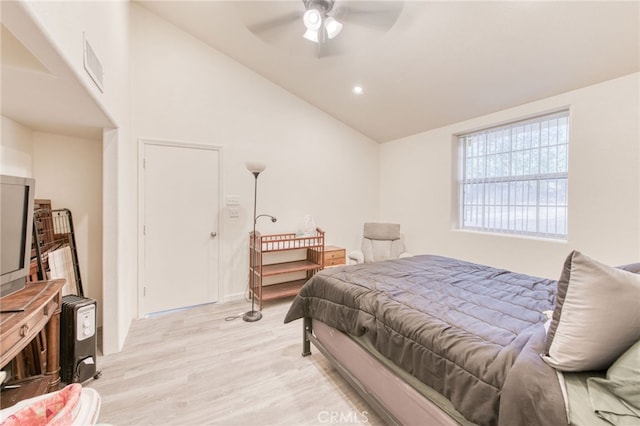 bedroom with ceiling fan, high vaulted ceiling, and light hardwood / wood-style floors