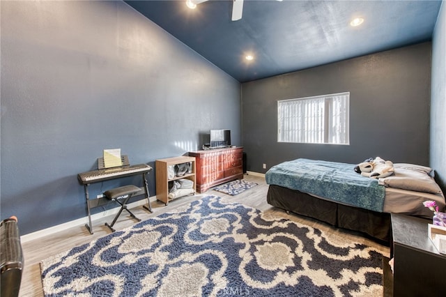 bedroom featuring ceiling fan, lofted ceiling, and light hardwood / wood-style floors