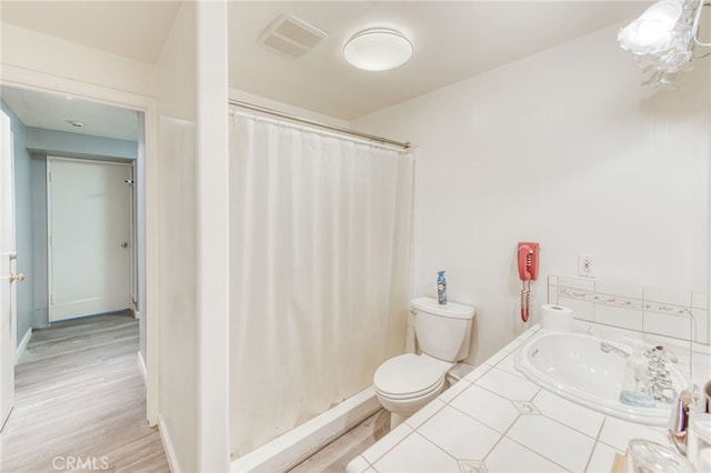 bathroom featuring toilet, vanity, a shower with curtain, and hardwood / wood-style flooring