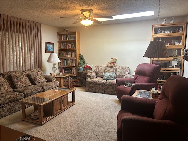 living room with ceiling fan, a textured ceiling, and carpet flooring