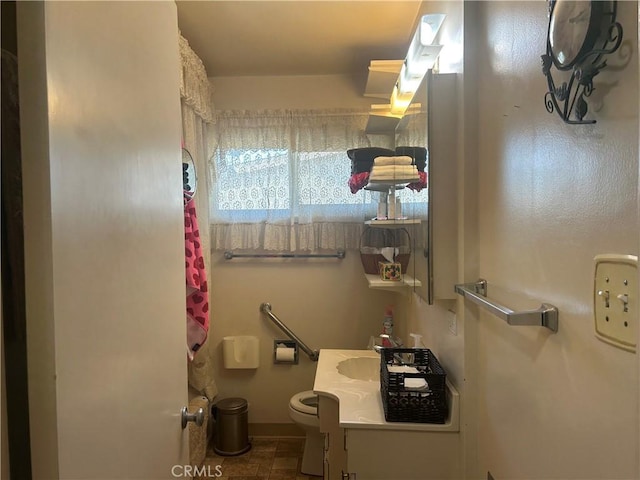 bathroom featuring toilet and vanity