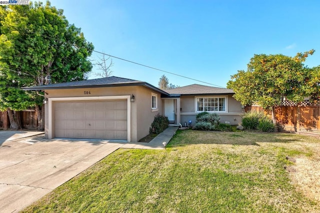 ranch-style house featuring a garage and a front lawn