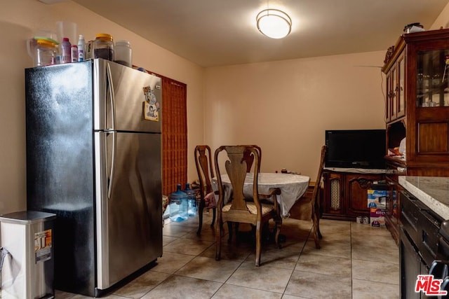 kitchen featuring stainless steel fridge and light tile patterned flooring