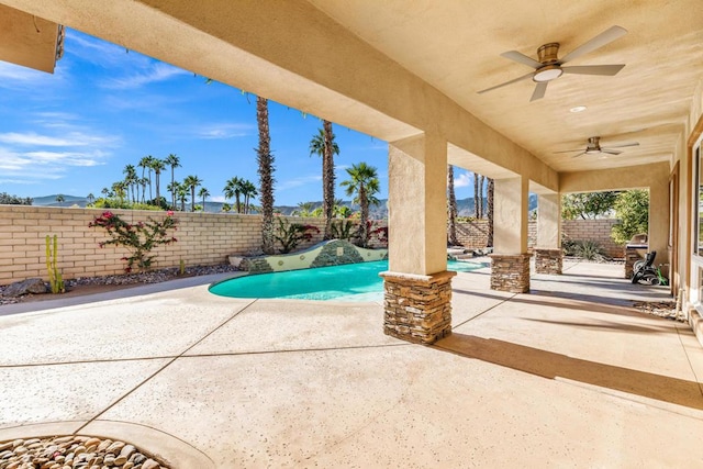 view of swimming pool with ceiling fan and a patio area