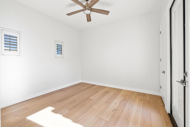 empty room with ceiling fan and light hardwood / wood-style floors