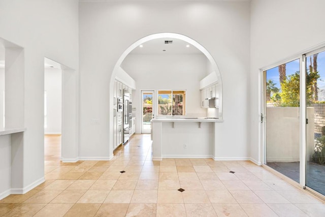 tiled entryway with a high ceiling