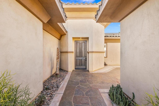 entrance to property with a patio