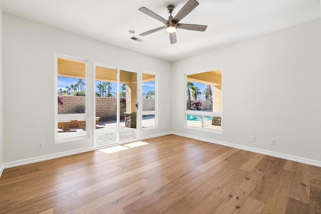 empty room with ceiling fan and light wood-type flooring