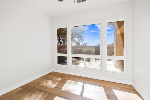 empty room featuring ceiling fan and hardwood / wood-style floors