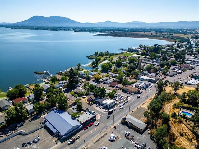 birds eye view of property with a water and mountain view