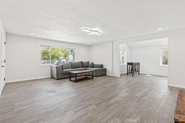 living room featuring recessed lighting, baseboards, and wood finished floors