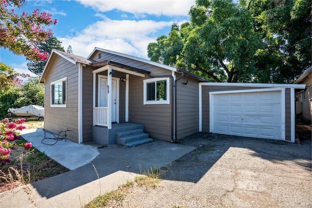 bungalow-style home with driveway and a garage