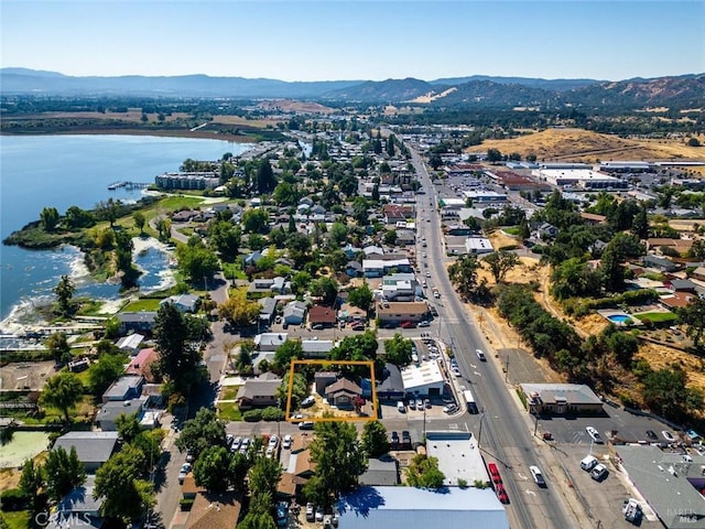 birds eye view of property with a water and mountain view