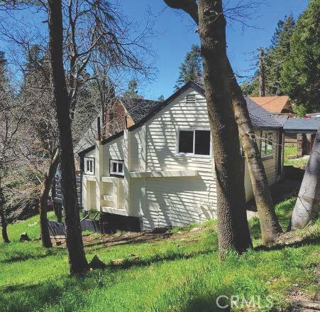 view of home's exterior with a yard