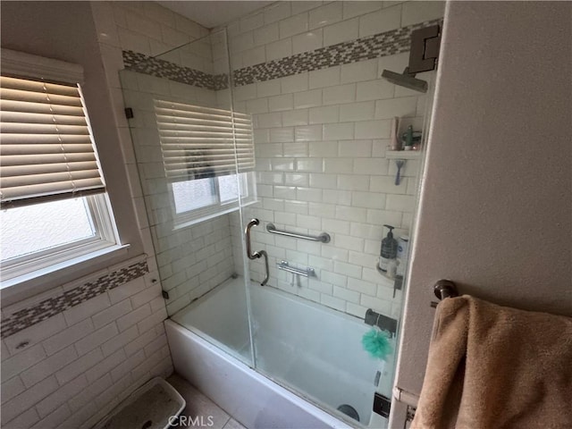 bathroom featuring shower / bath combination with glass door