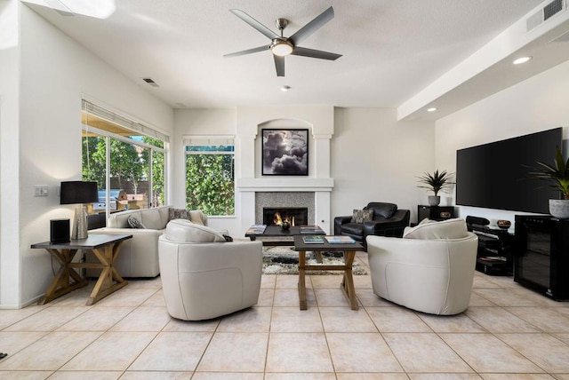 living room with ceiling fan and light tile patterned floors